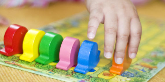 Child's hand with game pieces